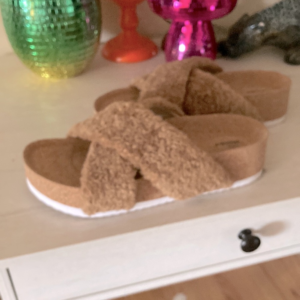 Chooka sandals with shearling straps and cork soles.